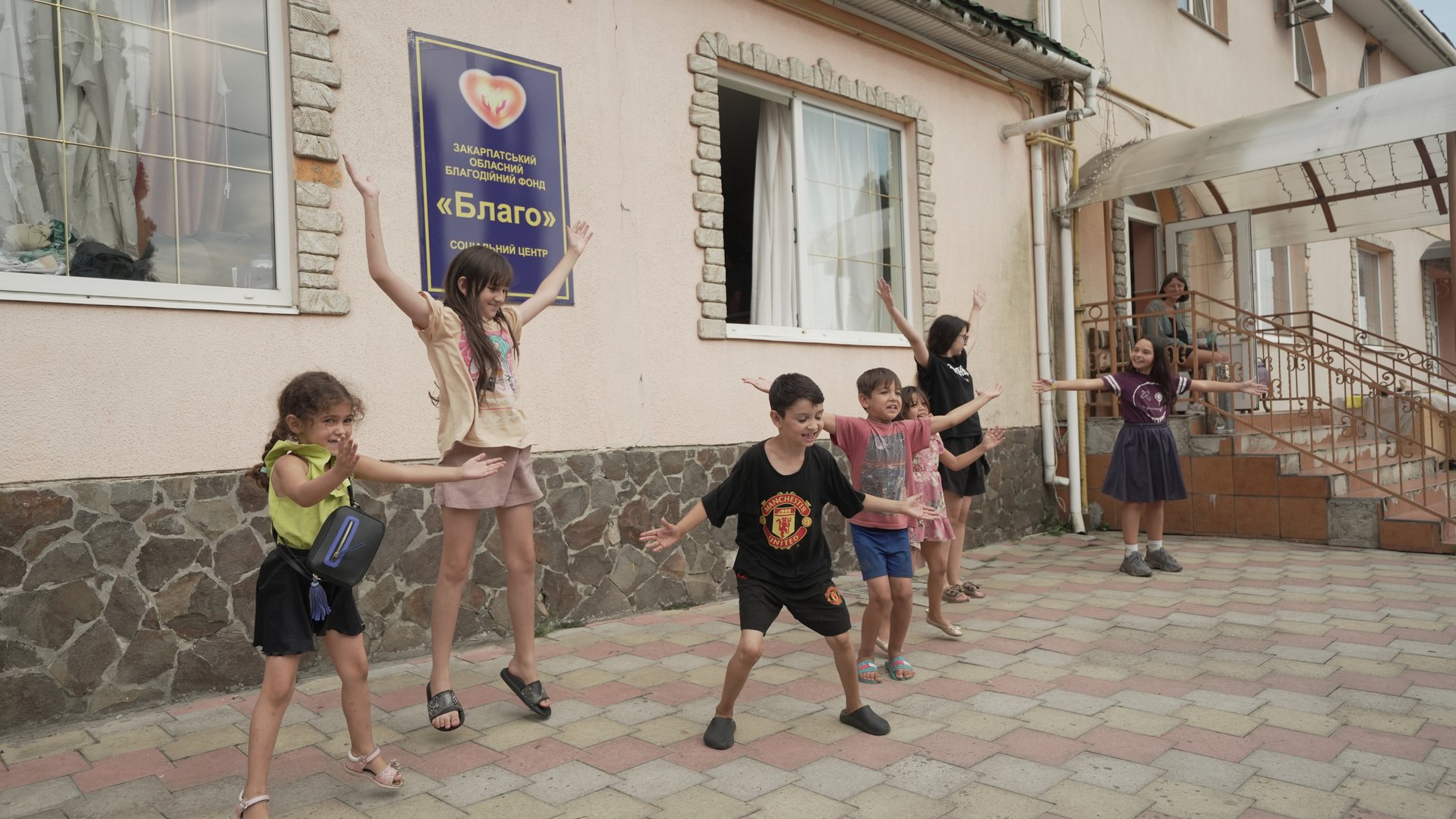 Children jumping outside the BLAHO shelter in Ukraine