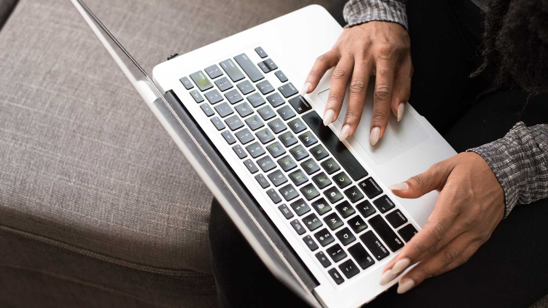 Hands on a laptop keyboard typing