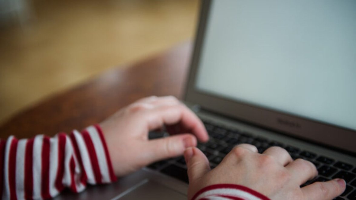 Hands on a laptop keyboard typing